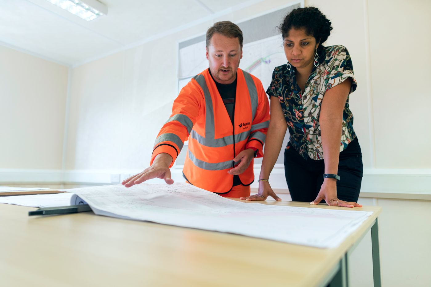 Construction Professionals Reviewing Building Plans Together